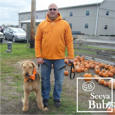 Dad and Lucy Standing at Pumpkin Patch with SB Logo